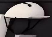 White helmet with a black lower guard on the garage wall.