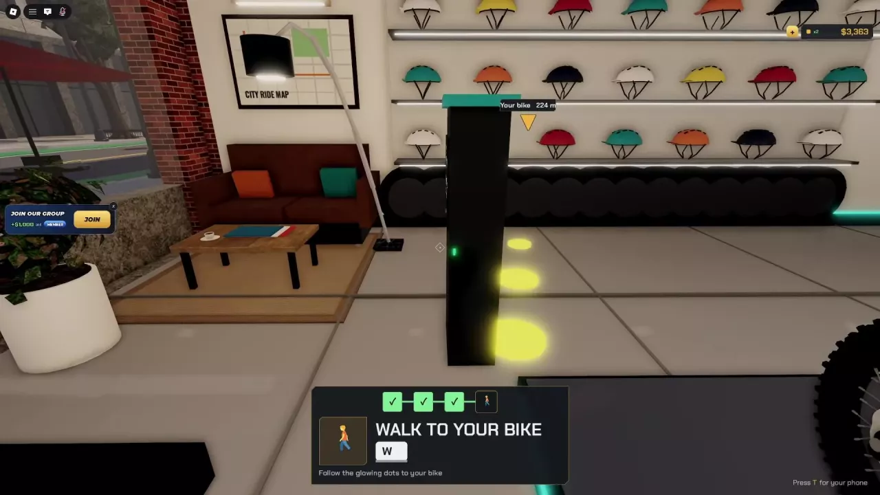 Black charging station with a teal top and green light beside Bike Hub&rsquo;s seating area.