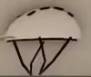 White helmet with black straps on the Bike Hub wall.